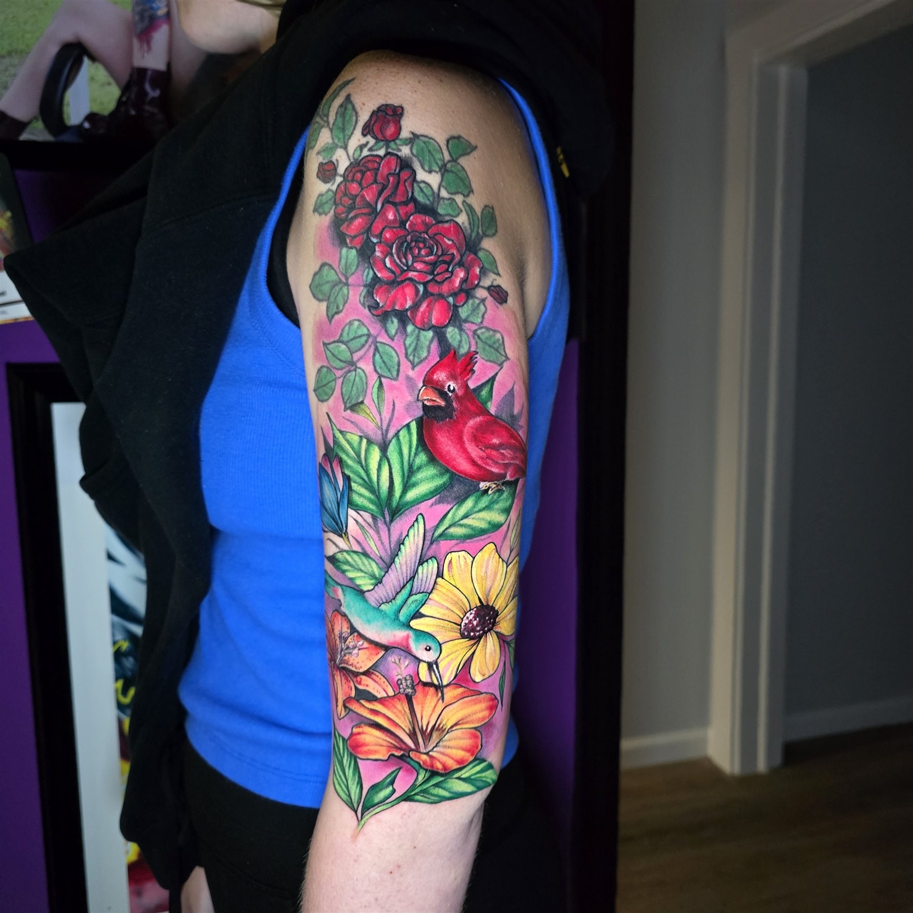 Full color cardinal, hummingbird, rose, and flower sleeve tattoo by Billy Smith