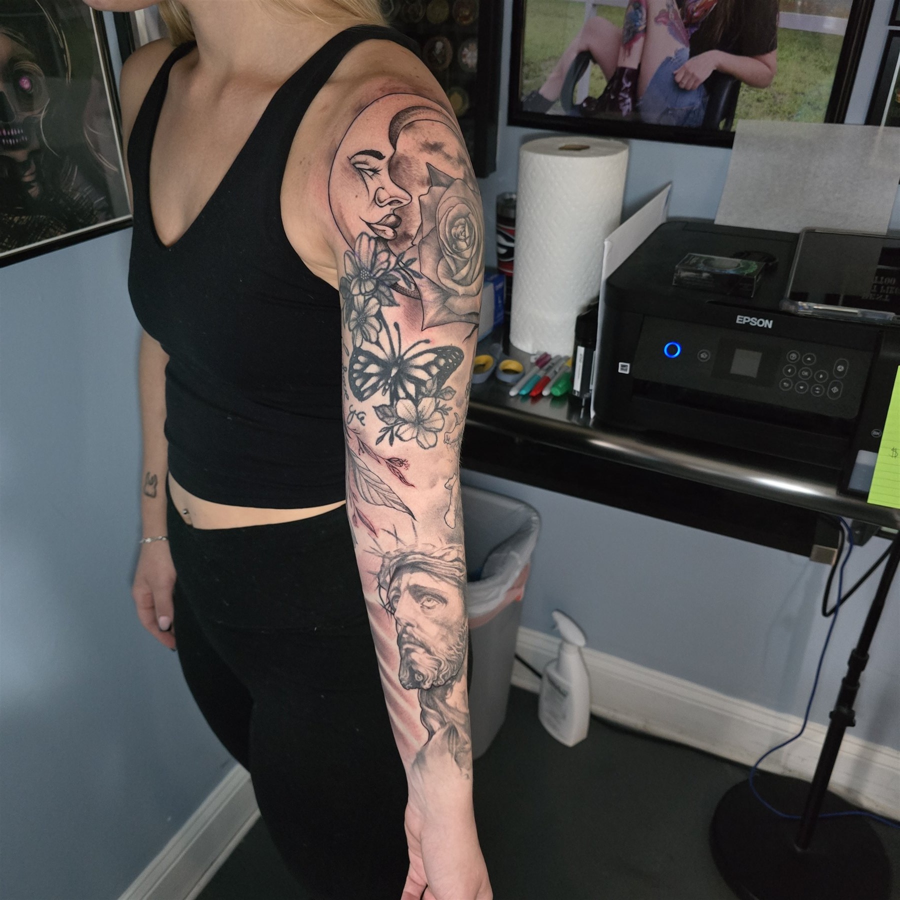 Black and grey faith, floral, and portrait sleeve tattoo by Billy Smith