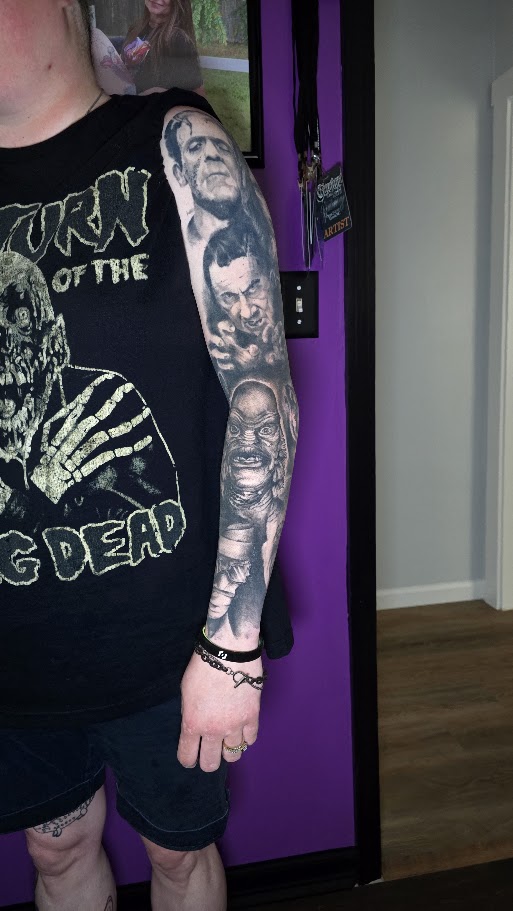 Outer view of a black and grey classic monster sleeve tattoo by Billy Smith