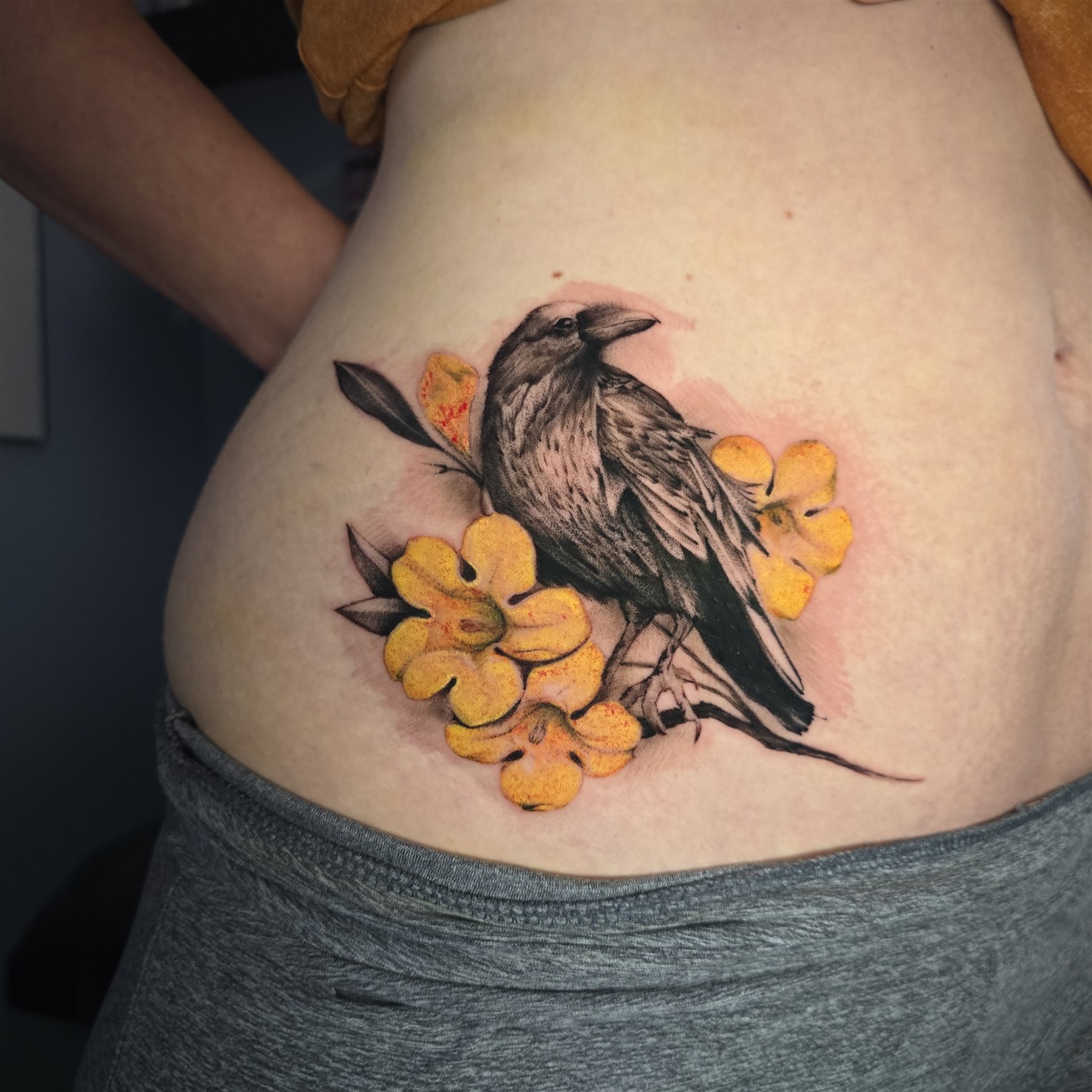 Black raven with yellow flower tattoo by Billy Smith