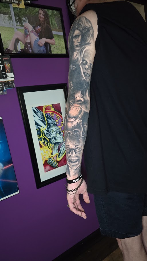 Inner view of a black and grey classic monster sleeve tattoo by Billy Smith